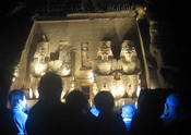 The audience, lit by a flash camera, in contrasting color  to Rameses' temple
