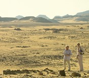 Empty desert:  tire tracks, two tourists