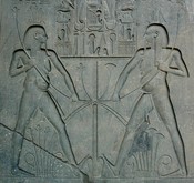 The famous <em>sema-tawi</em> scene on the side of Ramses' statue