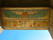 Above a doorway in Rameses III's temple, the sun god uses wings to protect us.