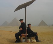 Two guards under a sun shield