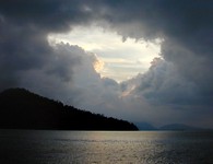 The hill on the left is on the island of Pangkor, which lies between Pangkor Laut island and the mainland of Peninsular Malaysia.  The background hills are on the mainland. (650x500, 74.2 kilobytes)