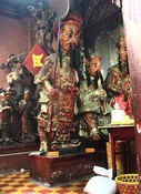 At the Jade Emperor Pagoda, one of his keepers of Heaven guards the entrance with an axe.