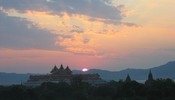 The sun sets over the Archeological Museum, the Ayeyarwady river, and the mountains behind.   FromShwegugyi
